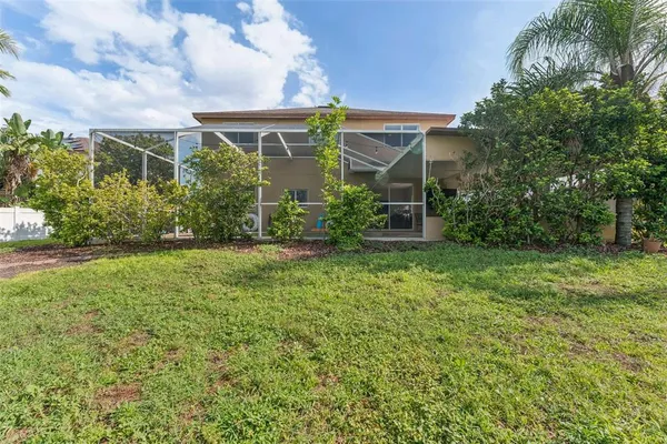 a view of a backyard with table and chairs potted plants