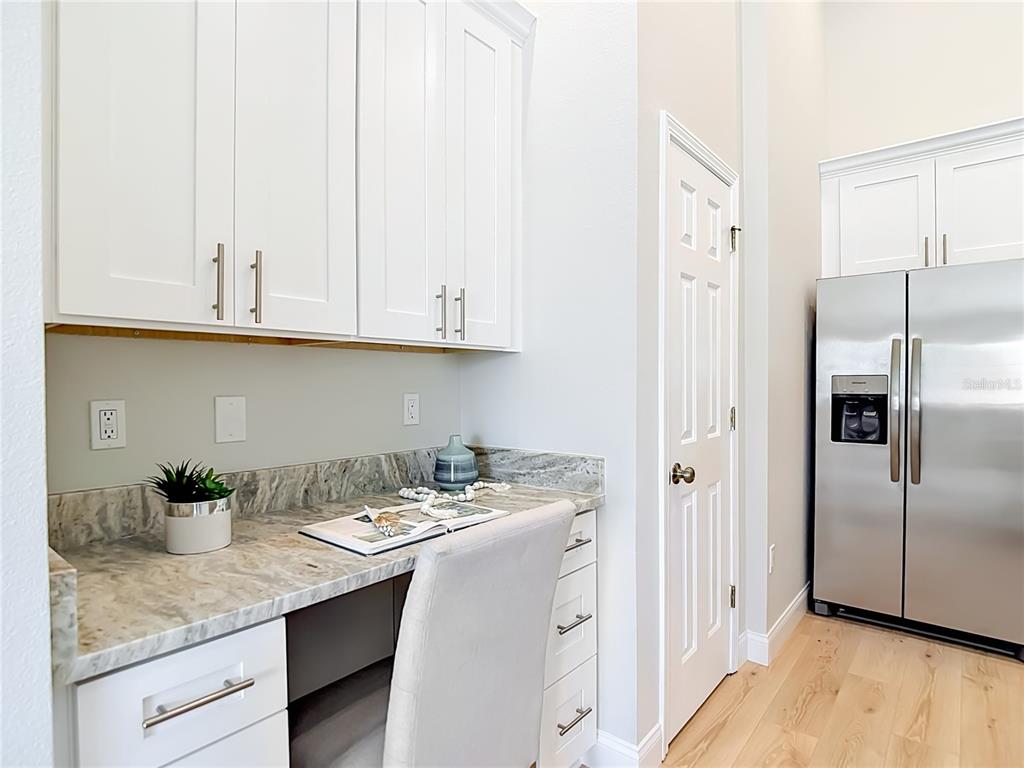 5310 Anhinga Trail New Port Richey, FL 34653 - Photo 7 of 27 a kitchen with stainless steel appliances granite countertop a sink a refrigerator and a granite counter tops