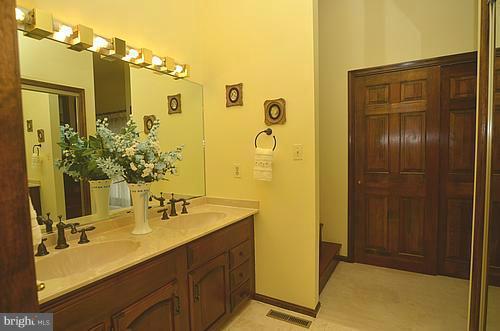 2111 Frederick Road Catonsville, MD 21228 - Photo 22 of 23 a bathroom with a double vanity sink a mirror and shower