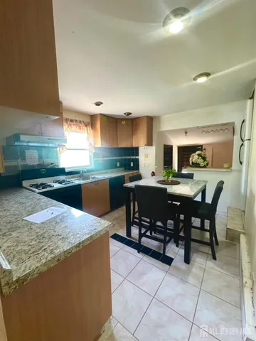 a kitchen with a table and chairs in it