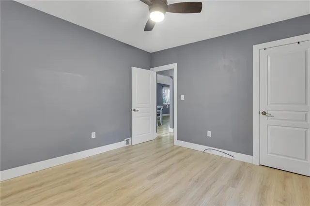 a view of an empty room and wooden floor