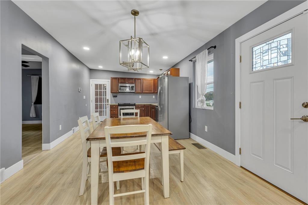 600 Neville Road Beaver, PA 15009 - Photo 8 of 23 a view of a dining room with furniture a chandelier and wooden floor