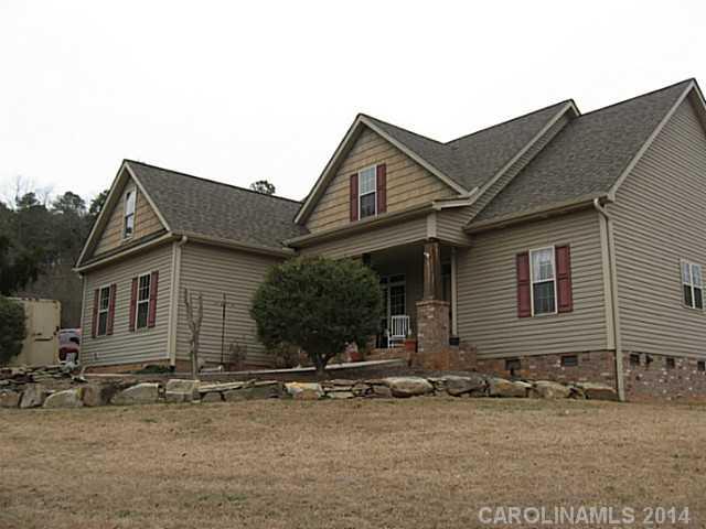 6028 Springhill Road, Unit 25 Stanfield, NC 28163 - Photo 14 of 15 front view of a house with that has a small yard and large tree