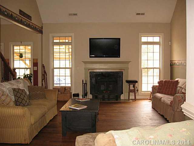 6028 Springhill Road, Unit 25 Stanfield, NC 28163 - Photo 4 of 15 a living room with furniture flat screen tv and a fireplace