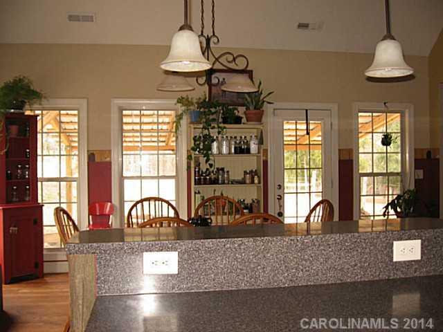 6028 Springhill Road, Unit 25 Stanfield, NC 28163 - Photo 6 of 15 a view of a dining room with furniture window and wooden floor