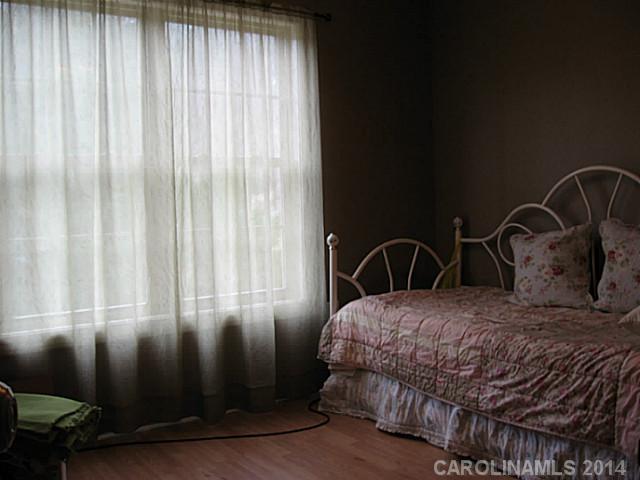 6028 Springhill Road, Unit 25 Stanfield, NC 28163 - Photo 8 of 15 a bedroom with a bed chair and a window
