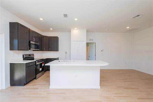 a kitchen with a sink and a refrigerator