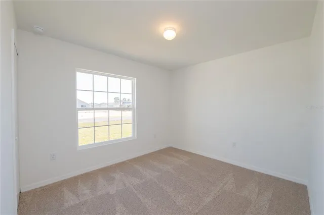 a bathroom with a granite countertop bathtub shower sink mirror vanity and a toilet