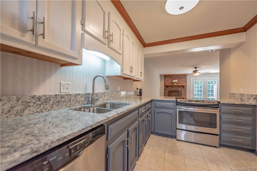 209 Eagle Road Belmont, NC 28012 - Photo 16 of 25 a kitchen with stainless steel appliances granite countertop a sink and dishwasher a stove top oven with wooden floor