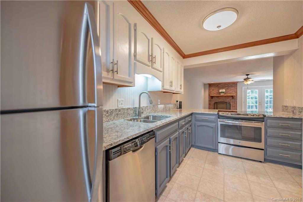 209 Eagle Road Belmont, NC 28012 - Photo 17 of 25 a kitchen with stainless steel appliances granite countertop a sink stove and refrigerator