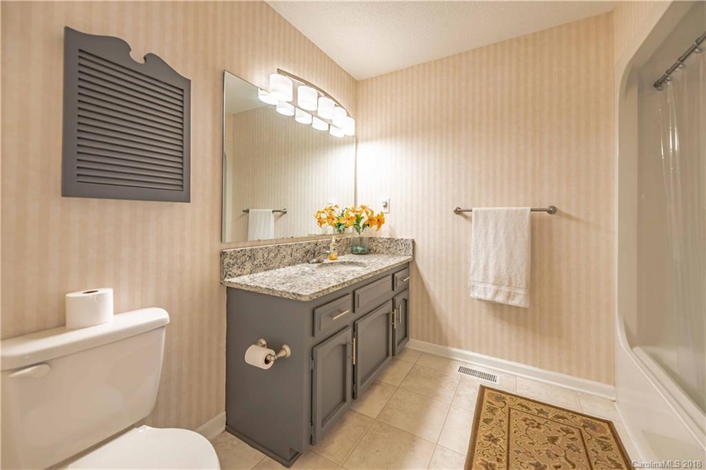 209 Eagle Road Belmont, NC 28012 - Photo 19 of 25 a bathroom with a granite countertop sink toilet and shower