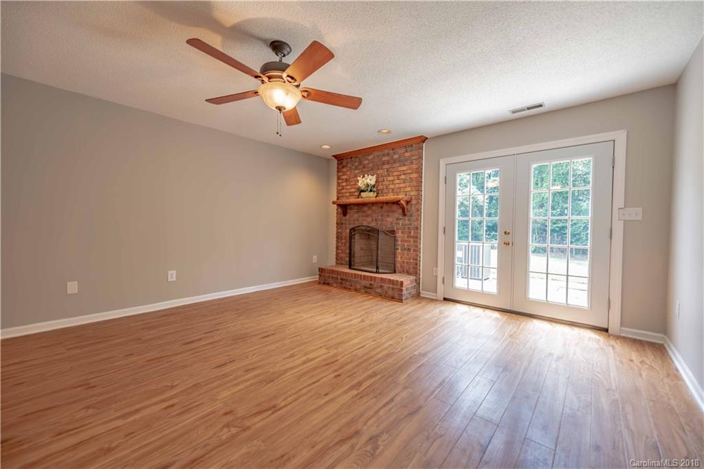 209 Eagle Road Belmont, NC 28012 - Photo 5 of 25 a view of an empty room with wooden floor and a window
