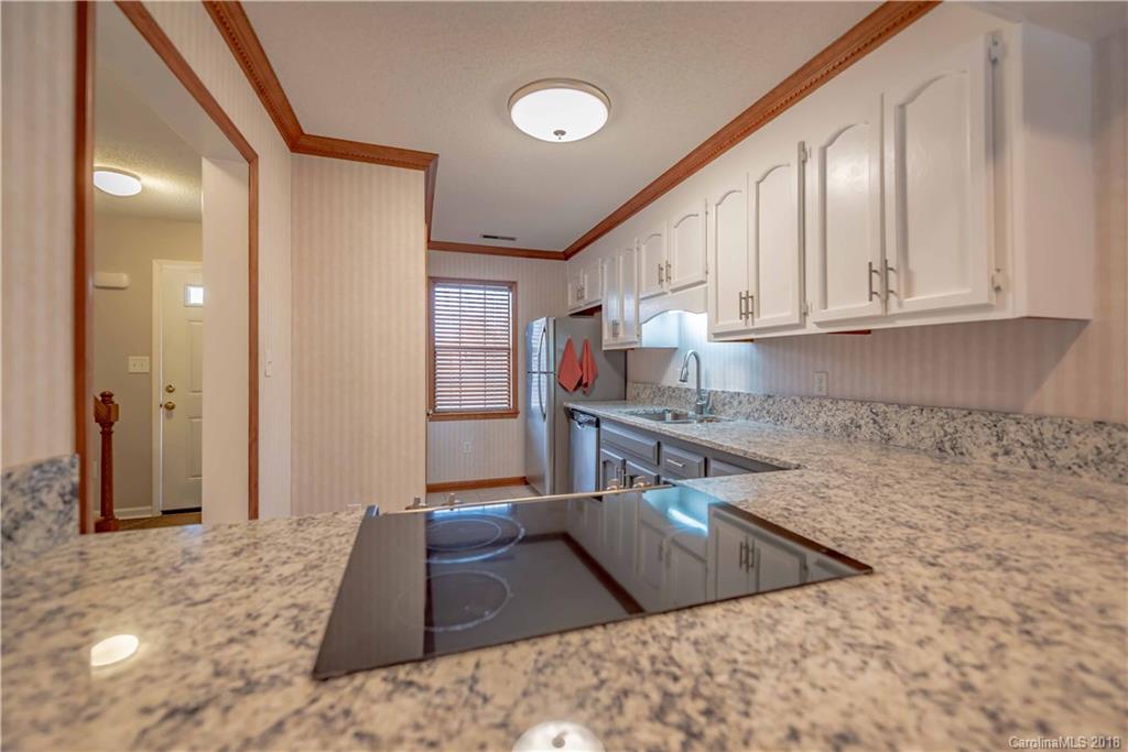 209 Eagle Road Belmont, NC 28012 - Photo 9 of 25 a kitchen with stainless steel appliances granite countertop a sink stove and refrigerator