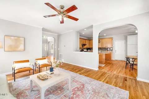 a living room with furniture and kitchen view