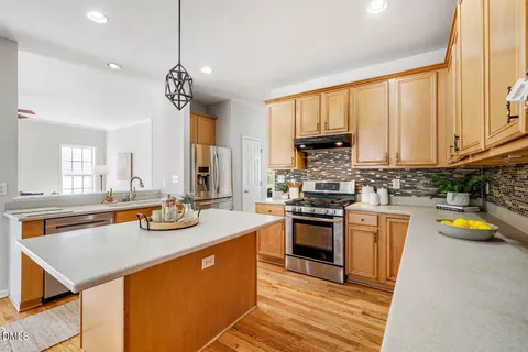 a kitchen with a stove a sink and a refrigerator