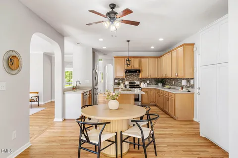 a kitchen with a table chairs and a refrigerator