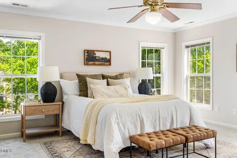a bedroom with a bed and a chandelier