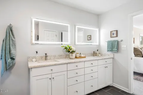 a bathroom with double sink and a mirror