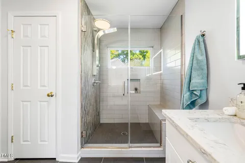 a bathroom with a shower and a sink