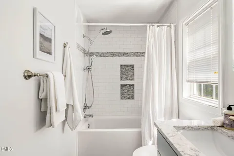 a bathroom with a granite countertop tub sink and a shower