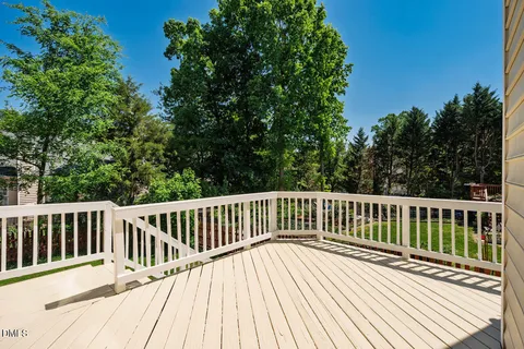 a view of balcony with wooden floor and fence