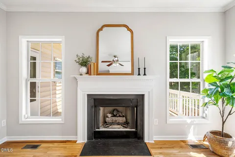 a living room with a fireplace and a window