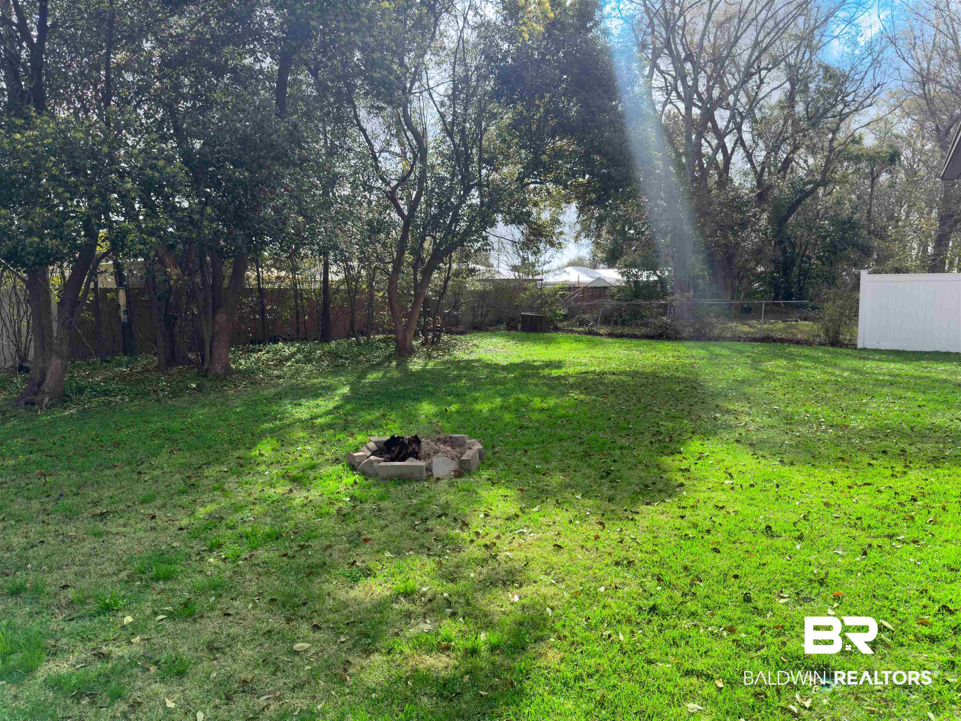 129 Pennbrooke Loop Foley, AL 36535 - Photo 35 of 44 Fenced backyard featuring an outdoor fire pit