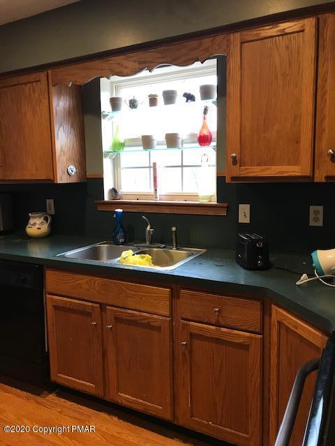 3504 Hill Run Road Effort, PA 18330 - Photo 3 of 22 a kitchen with granite countertop cabinets stainless steel appliances a sink and a window