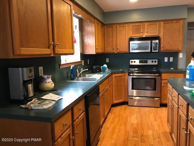 3504 Hill Run Road Effort, PA 18330 - Photo 4 of 22 a kitchen with stainless steel appliances a stove sink microwave and cabinets