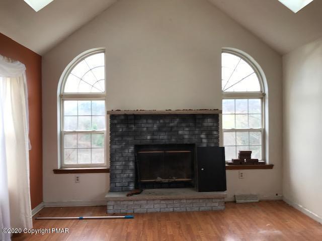 3504 Hill Run Road Effort, PA 18330 - Photo 6 of 22 a living room with a fireplace and windows