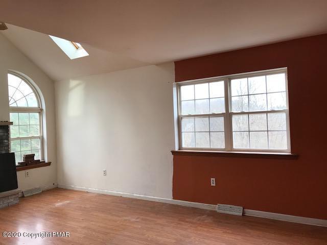 3504 Hill Run Road Effort, PA 18330 - Photo 7 of 22 an empty room with wooden floor and windows