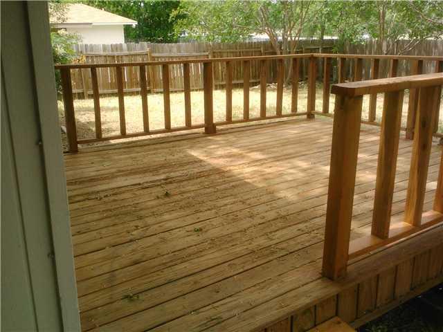10612 Hard Rock Road Austin, TX 78750 - Photo 5 of 5 A spacious wooden deck provides an inviting outdoor living area for relaxation.