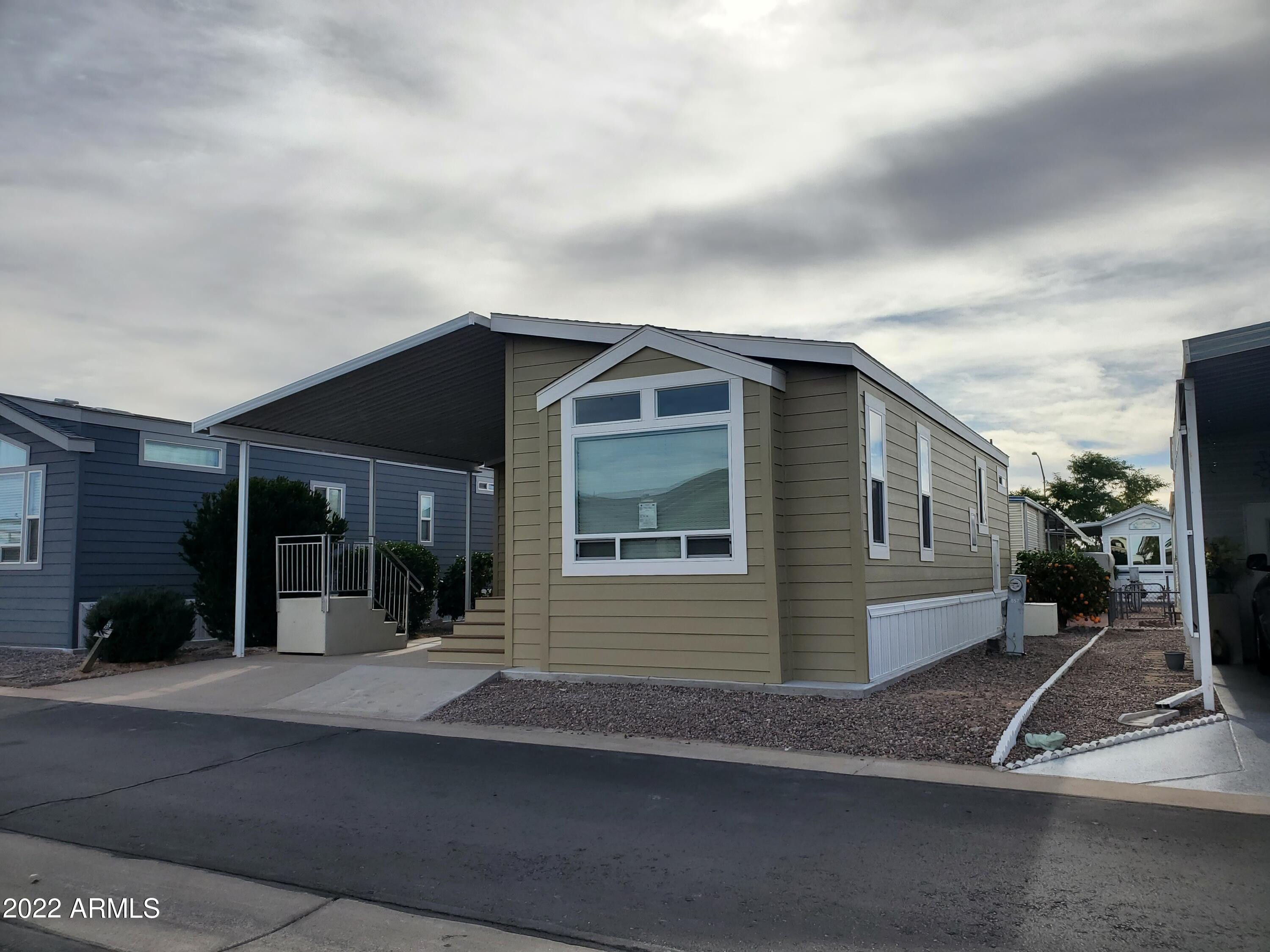 7750 East Broadway Road, Unit LOT 857 Mesa, AZ 85208 - Photo 11 of 17 a view of a house with a yard