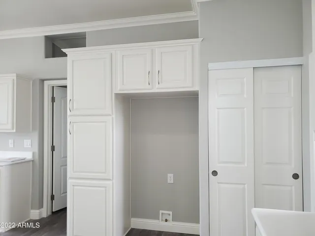 a view of cabinets and bathroom with a sink