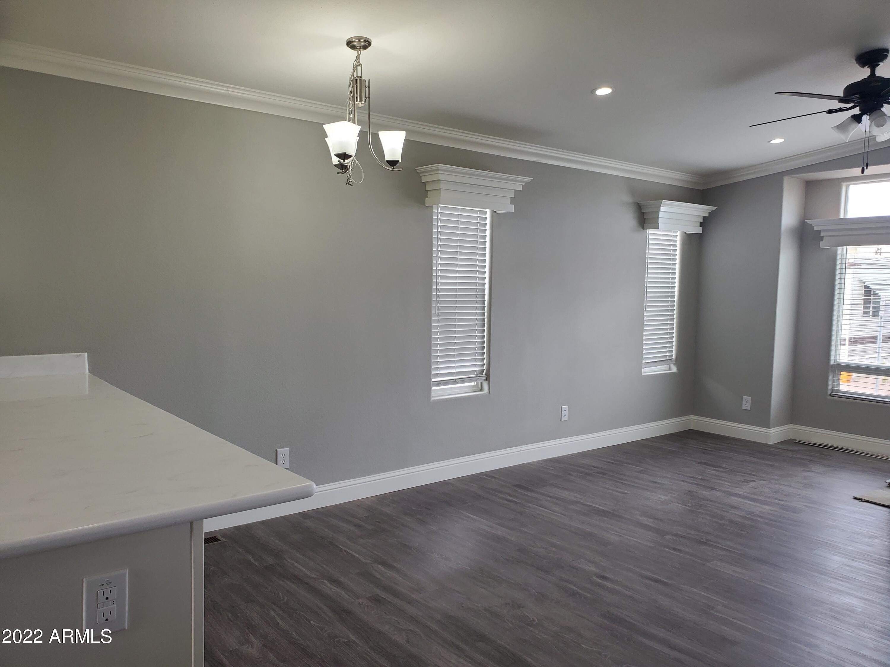 7750 East Broadway Road, Unit LOT 857 Mesa, AZ 85208 - Photo 6 of 17 wooden floor in an empty room with a window