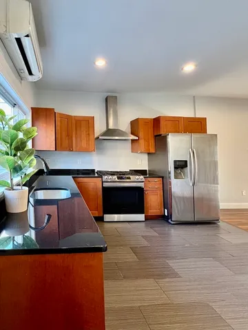 a kitchen with stainless steel appliances granite countertop a sink and a stove