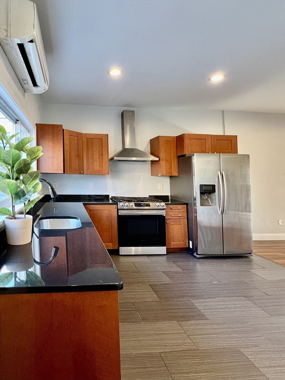 a kitchen with stainless steel appliances granite countertop a sink and a stove