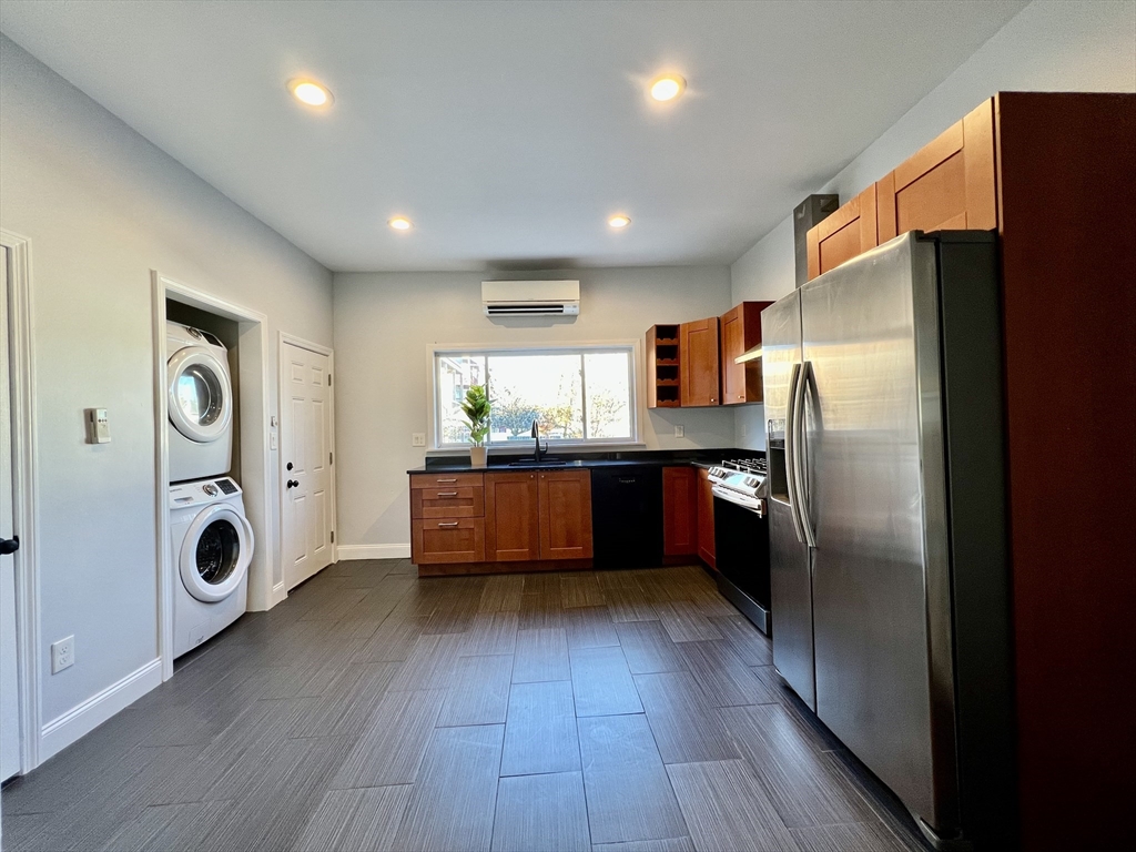 113 Moore Street, Unit 2 Boston, MA 02128 - Photo 14 of 19 a kitchen with stainless steel appliances a refrigerator and a wooden floor