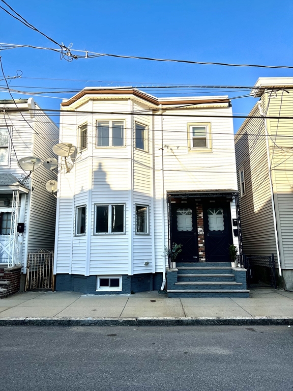113 Moore Street, Unit 2 Boston, MA 02128 - Photo 17 of 19 a front view of a house with a garage