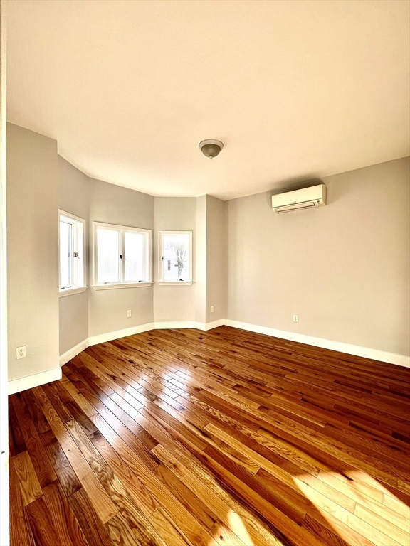 113 Moore Street, Unit 2 Boston, MA 02128 - Photo 4 of 19 a view of empty room with wooden floor and fan