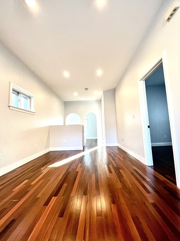113 Moore Street, Unit 2 Boston, MA 02128 - Photo 5 of 19 a view of empty room with wooden floor