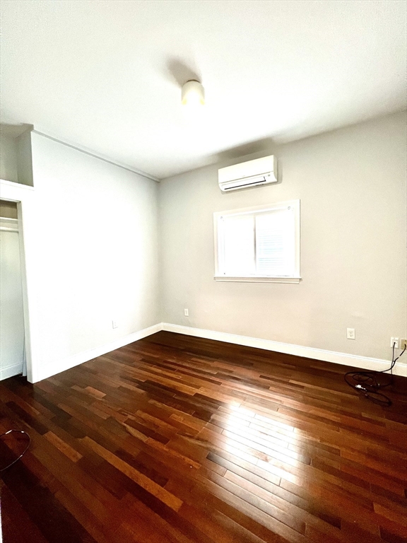 113 Moore Street, Unit 2 Boston, MA 02128 - Photo 6 of 19 a view of an empty room and wooden floor