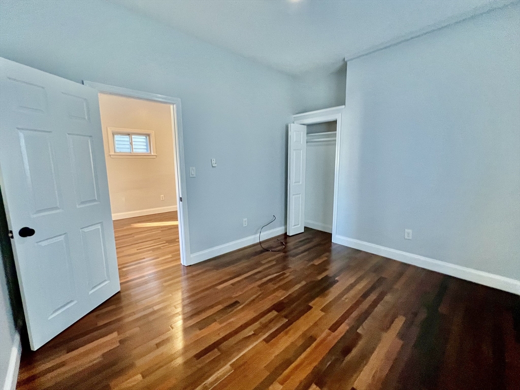 113 Moore Street, Unit 2 Boston, MA 02128 - Photo 7 of 19 a view of an empty room with wooden floor and a window