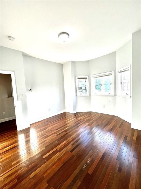 113 Moore Street, Unit 2 Boston, MA 02128 - Photo 8 of 19 a view of empty room with wooden floor and fan