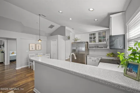 a kitchen with a sink cabinets and wooden floor