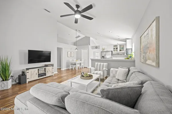 a living room with furniture and a flat screen tv