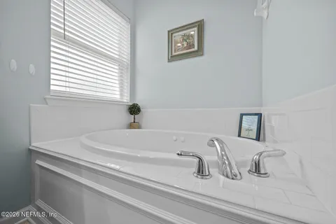 a bedroom with a bed and a chair