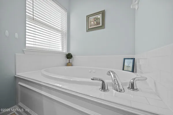 a bedroom with a bed and a chair