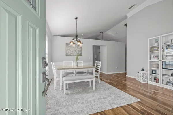 a view of a dining room with furniture window and wooden floor