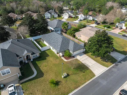 an aerial view of a house with a yard and lake view